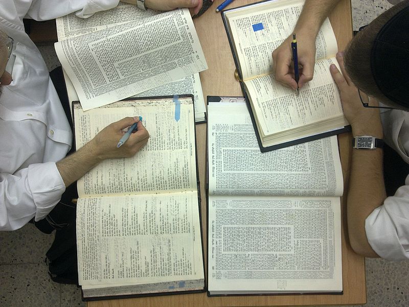 Two Jewish men studying the Talmud, a compendium of Oral Law.